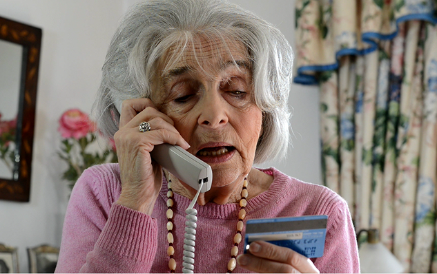 woman on phone with credit card