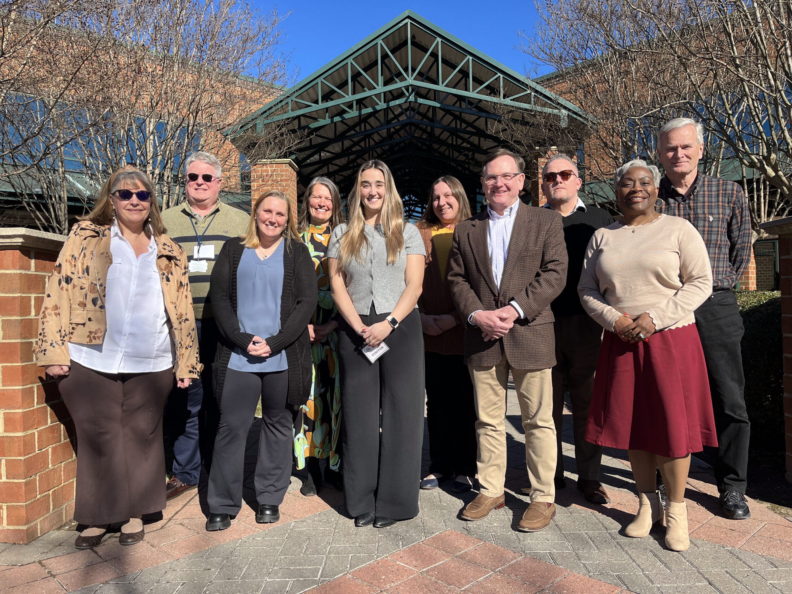 Employment Service Organization Steering Committee board members stand for a group photo outside of the DARS central office in Innsbrook in Glen Allen, VA. in January 2026.